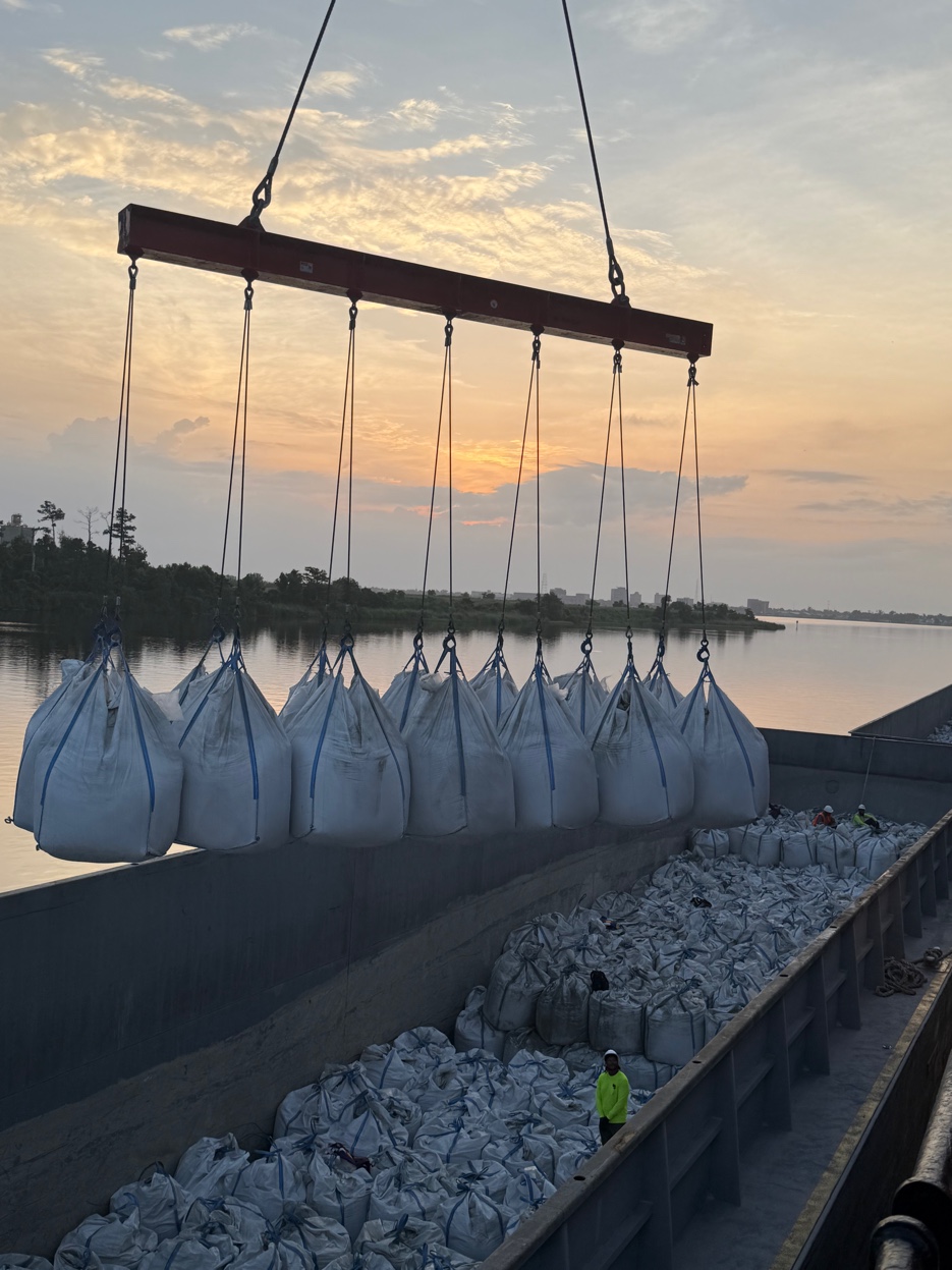 GCS Industrial Group — supersacks being lifted at sunset on the Gulf Coast waterway