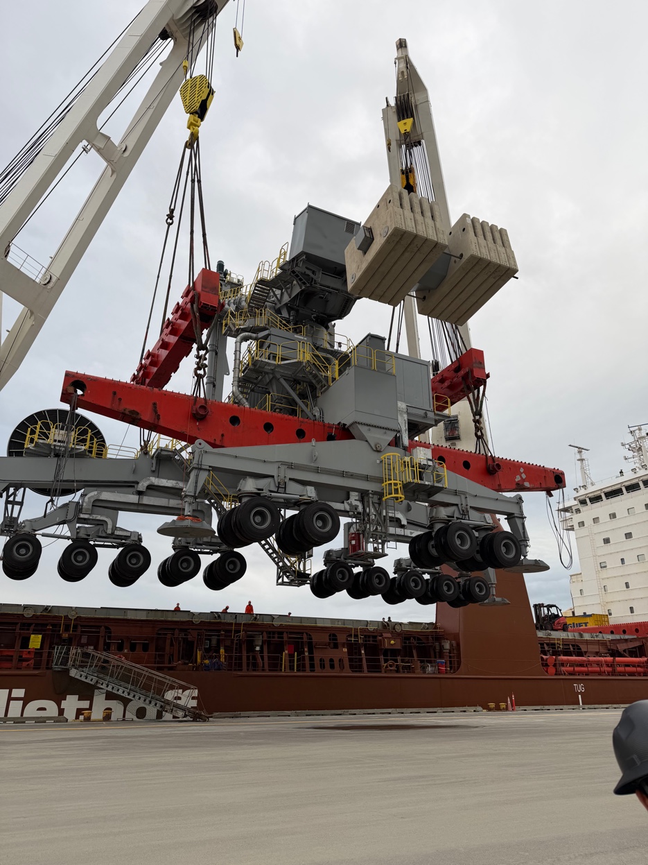 GCS Industrial Group heavy lift operation — large industrial machinery lifted by crane at port berth