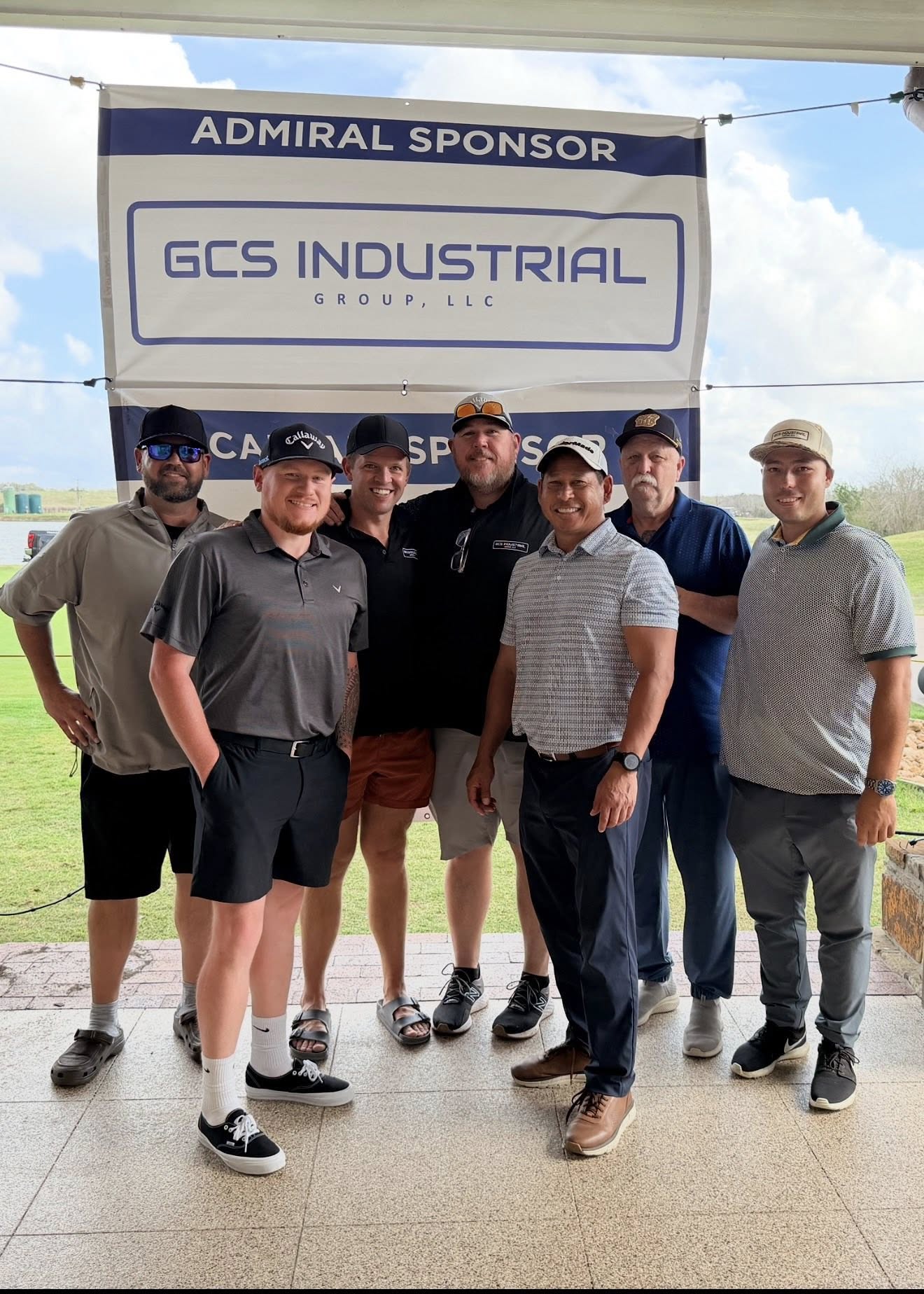 GCS Industrial Group team at Propeller Club of Houston golf tournament, standing in front of GCS Admiral Sponsor banner
