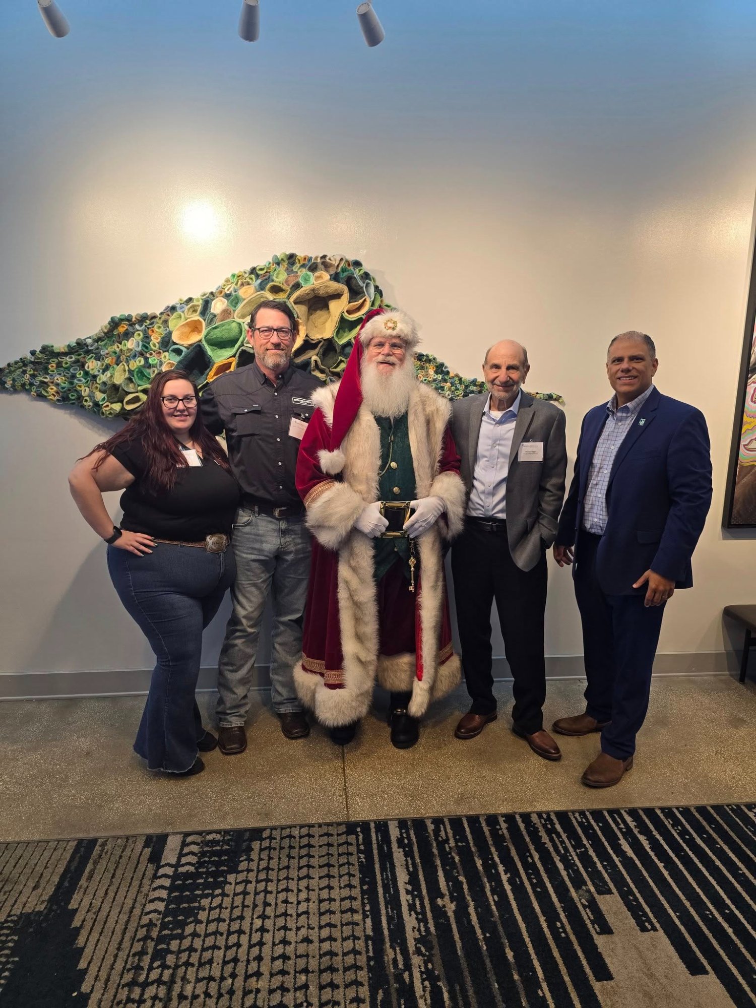 GCS team at Propeller Club Tampa Holiday Luncheon with festive holiday backdrop