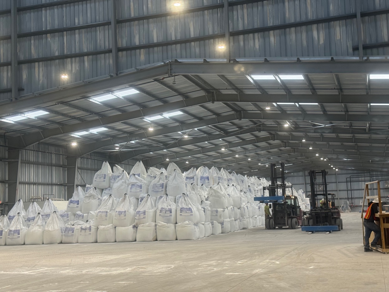 GCS Industrial Group warehouse operations — rows of stacked cement supersacks with forklift