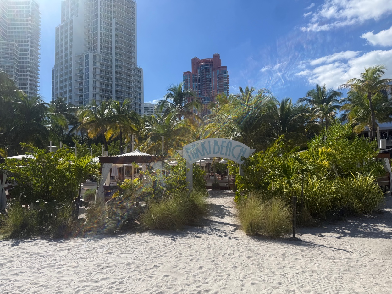 Nikki Beach Miami South Beach — waterfront venue on white sand with palm trees and Miami skyline